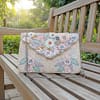 1446b6d0-bdf3-423a-8766-4a3b40d04b32 Pastel Garden Handcrafted Floral Embroidered Clutch